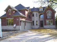 wood entry door in large brick and stone house