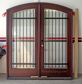 custom made arched double doors with iron bars after finishing